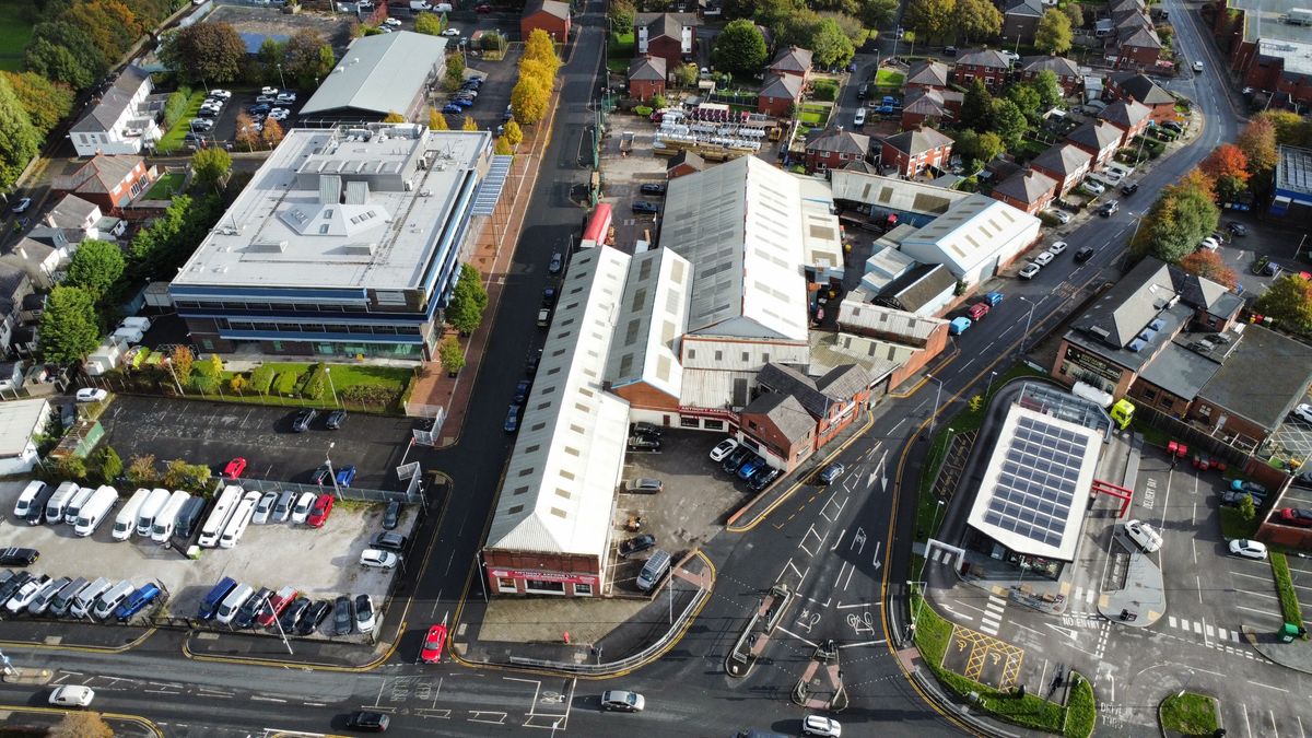 Aerial view of the Atlas Sawmill site on King Street, Farnworth, showing the main shed roofs, the timber yard behind and the surrounding roads