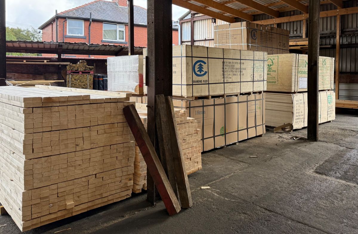 Stacks of sawn C16 timber and FSC plywood stored under cover at the Axfords Timber yard in Farnworth